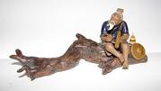 China Man sitting on a log Figurine
